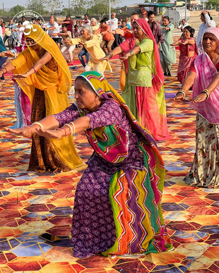 Women practitioners performing yoga poses together at the OM Ashram Shiva Temple.